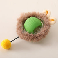 Placeholder: green rolling ball dog toy in tan plush cover with ears and yellow pom-pom tail