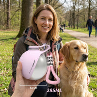 Placeholder: woman and golden retriever in a park with pink stainless steel travel water bottle