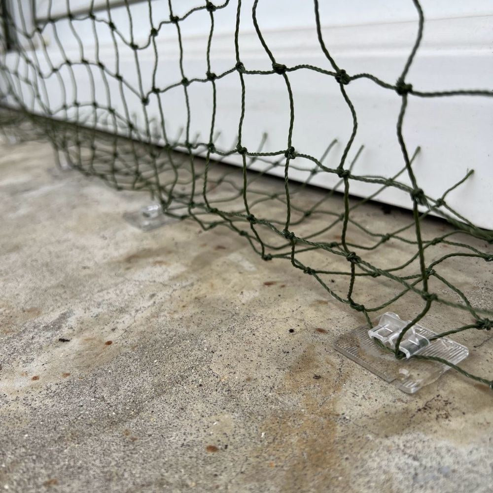 Placeholder: green net secured with clear adhesive clips