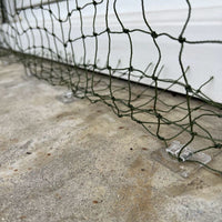 Placeholder: green net secured with clear adhesive clips