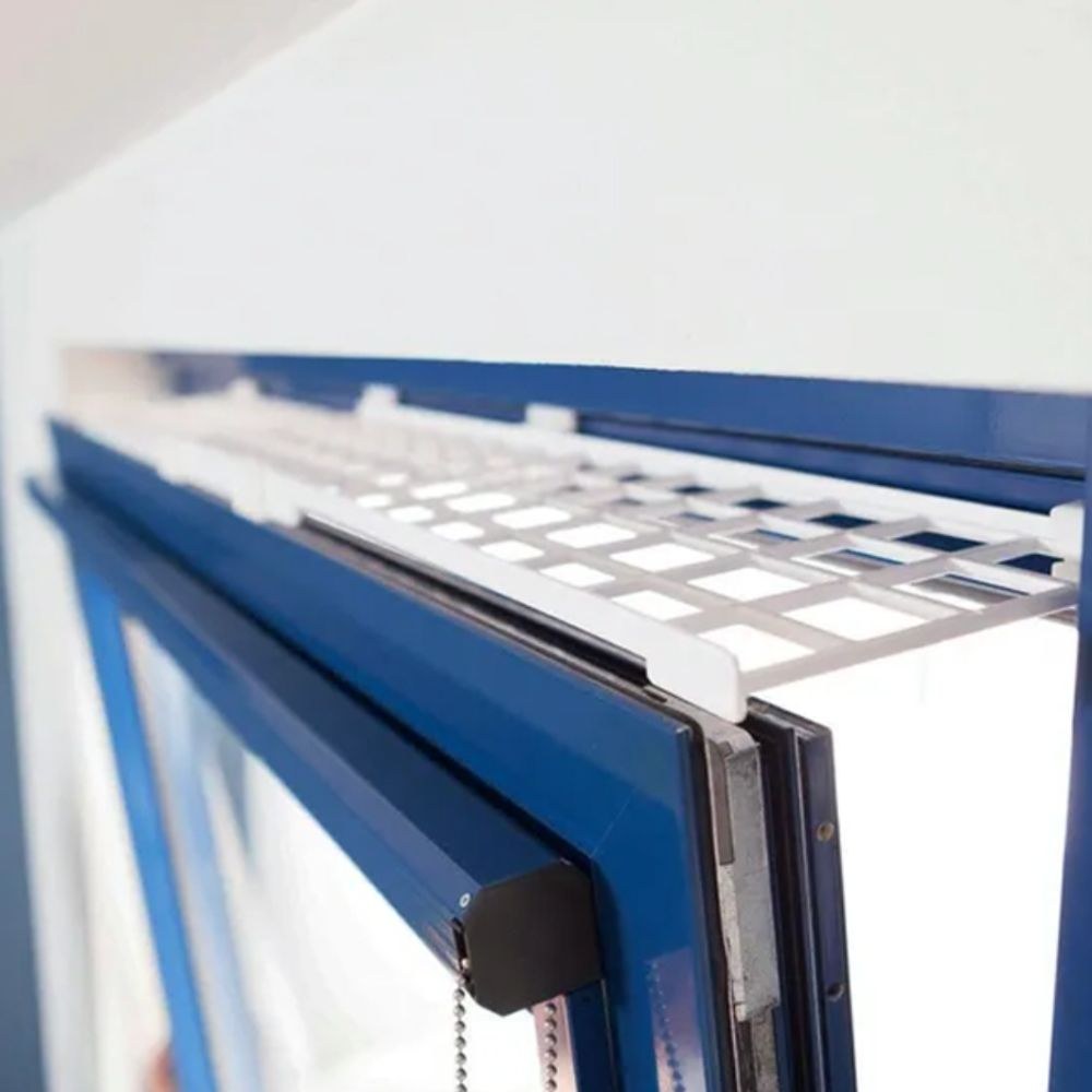 Placeholder: white mesh guard at the top of a tilted window